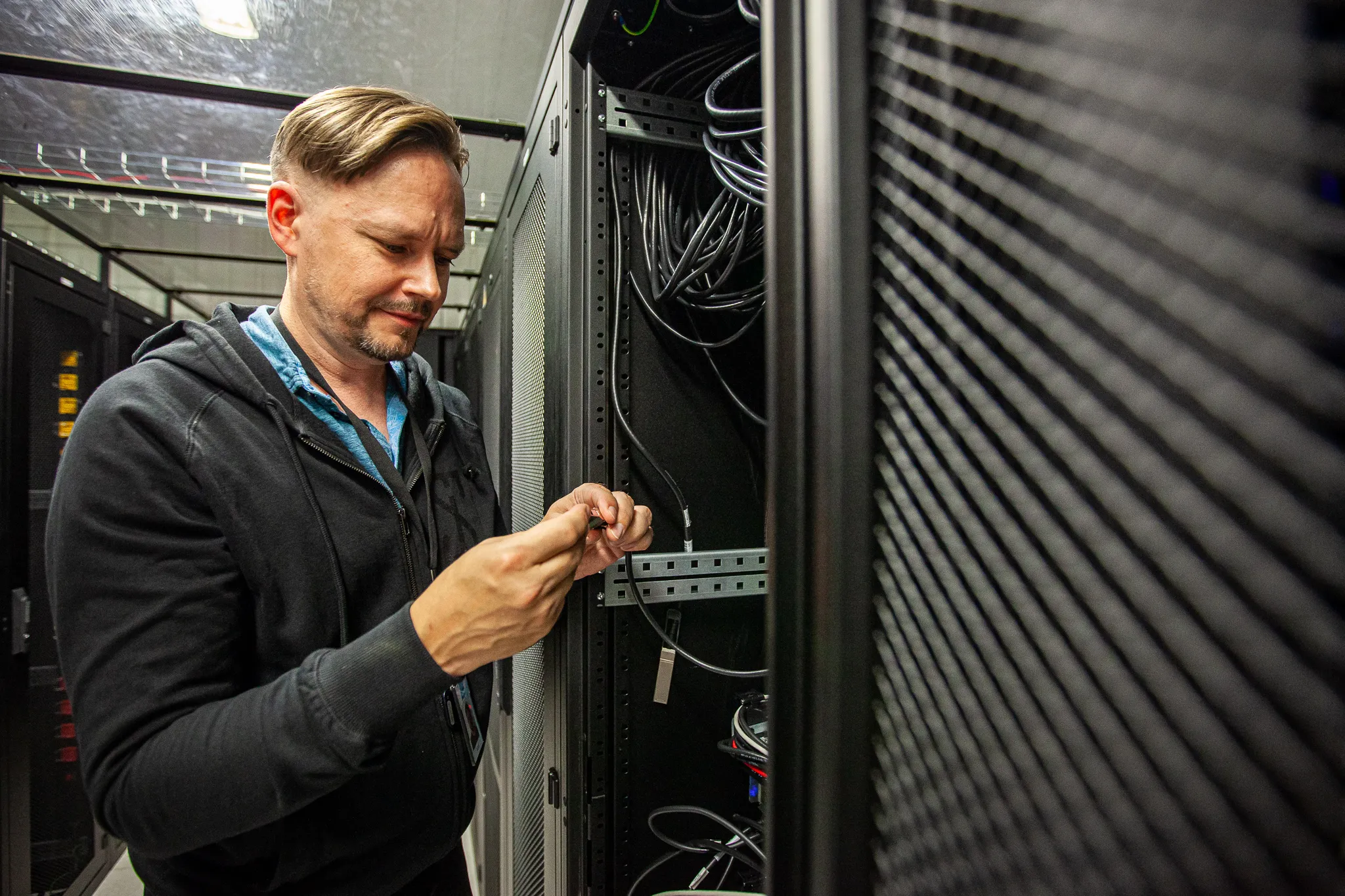 SpaceTime engineer fixing cables in the datacenter